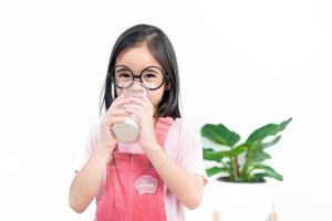 child asia girl  drink milk with a glass photo