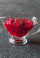 Cranberry sauce in glass gravy boat photo