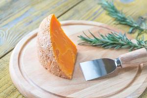 Mimolette cheese on the wooden board photo