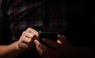 man's hand using a mobile phone browsing mobile device apps, reading news, chatting or shopping online, searching information in internet, holding smartphone, internet business, digital marketing photo