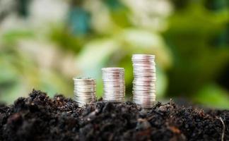 pile of silver coins with green nature background. money saving and business finance concept, business growth and money future, financial success photo