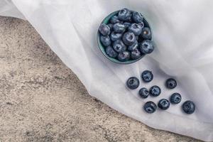 Raw Organic Blueberries in a Bowl on a gray background, photo
