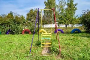 Photography on theme empty playground with metal swing for kids photo