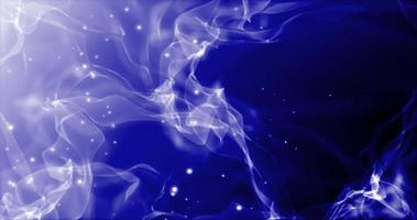 Abstract blue smoke flies in waves and flying particles are bright glowing with a blur effect. Abstract background photo
