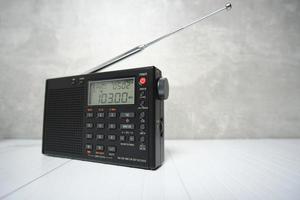 Digital radio receiver with elongated antenna gray concrete background. photo