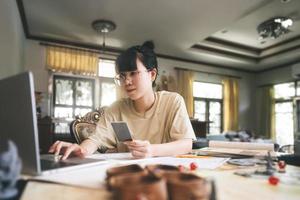 sian woman using laptop for half role playing tabletop and board game with online friends photo