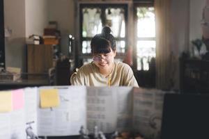 Young adult asian woman enjoying role playing tabletop and board games photo