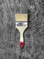 Paint brush on vintage wooden table photo