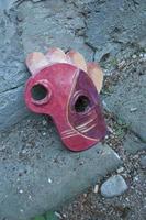 Carnival in Italy. Abandoned ceramic mask on the street photo