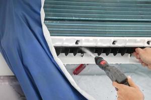 air conditioning cleaning service with water spray photo