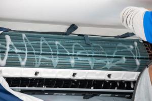 air conditioning cleaning service with water spray photo