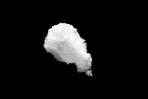 White snow isolated on black background close up photo