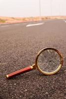 Magnifying glass on the road photo