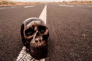 Miniature skull on the road photo