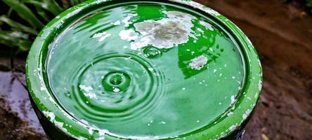 This photo of water waves is produced from raindrops falling on a bucket