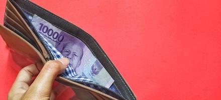 Portrait of Indonesian banknotes worth 10,000 rupiah in a wallet. photo