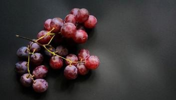 Vitis vinifera fruits isolated on black background and negative space. photo