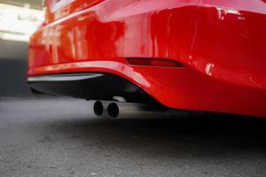 Stainless exhaust pipe at the bottom of car selective background photo