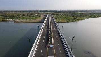 Aerial view of the Kretek 2 bridge which is the southern causeway bridge. Close to Depok beach, Bantul, Indonesia. Has a keris monument icon. photo