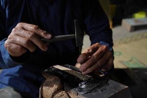 The process of making a keris is being carved to make traditional ornaments photo