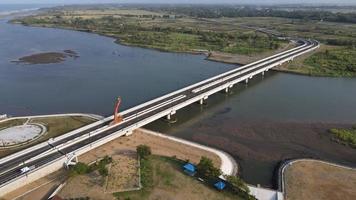 Aerial view of the Kretek 2 bridge which is the southern causeway bridge. Close to Depok beach, Bantul, Indonesia. Has a keris monument icon. photo
