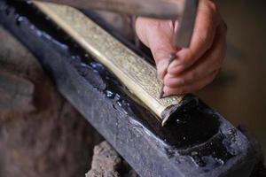 The process of making a keris is being carved to make traditional ornaments photo