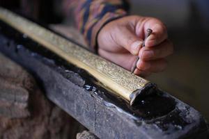 The process of making a keris is being carved to make traditional ornaments photo