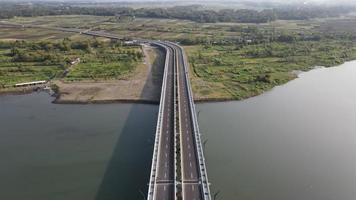 Aerial view of the Kretek 2 bridge which is the southern causeway bridge. Close to Depok beach, Bantul, Indonesia. Has a keris monument icon. photo