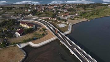 Aerial view of the Kretek 2 bridge which is the southern causeway bridge. Close to Depok beach, Bantul, Indonesia. Has a keris monument icon. photo