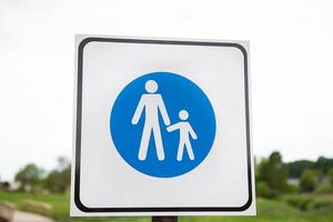 Road blue sign adults and children. Safety and caution concept. Safety regulations. photo