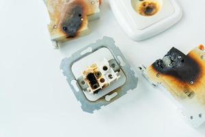 Electrical short circuit. Failure caused by burning wire and rosettes socket plug in house. photo