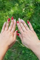 The girl shows a bad old manicure. Overgrown nail polish, broken nail. Manicure correction, old manicure. Nail care, it's time to go to the salon. photo