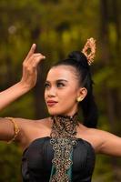 Portrait of a Balinese woman with beautiful makeup and tied black hair on a brave facial expression photo