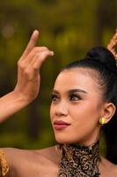 Portrait of a Balinese woman with beautiful makeup and tied black hair on a brave facial expression photo