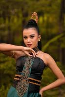 The fierce face of an Indonesian woman wearing makeup on her face and a black costume after a dance performance photo