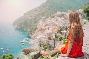 adorable niña en un cálido y soleado día de verano en la ciudad de positano en italia foto