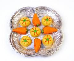 Delicious carrot shape Sweets of India on a plate photo