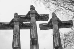 grayscale shot of three crosses in the graveyard photo