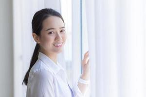 Asian beautiful woman has black long hair in white shirt. photo