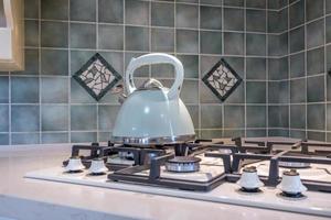 kettle on gas stove in modern kitchen photo