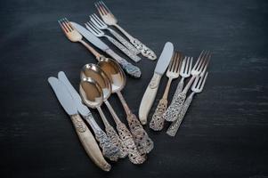 Tarnished silverware on a dark background. photo