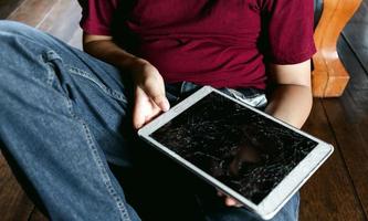 Portrait of a little Asian boy, Kid sad face, Unhappy child sitting holding  broken tablet computer, Emotion sad and sad face, depressed children concept photo