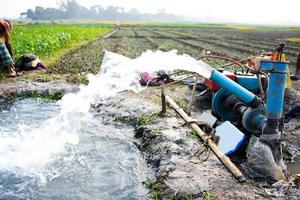 Irrigation of rice fields using pump wells with the technique of pumping water from the ground to flow into the rice fields. The pumping station where water is pumped from a irrigation canal. photo