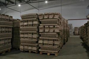 Storage warehouse with packaged goods on wooden pallet at recycle paper factory. Preparation shipment of products. Logistics, transportation and distribution facility for delivery. Supply chain cargo photo