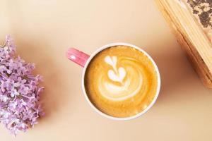 Cup of coffee and anemones flower bouquet and vinage books. Spring, Mother's Day or March 8 flat lay composition photo