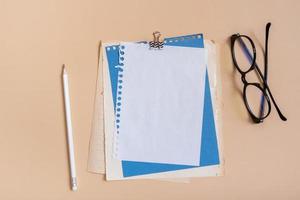 Blank sheet paper for note and pencil on colored background top view. Flat lay photo