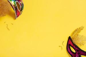 Festive face mask for carnival or masquerade celebration on colored background with copy space photo