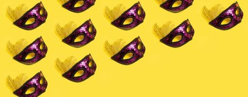 Festive face mask pattern for carnival or masquerade celebration on colored background. Banner format photo