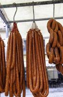 Sausages hanging in a market photo