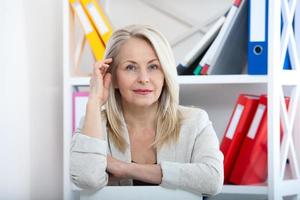 Modern businesswoman. Beautiful middle aged woman looking at camera photo